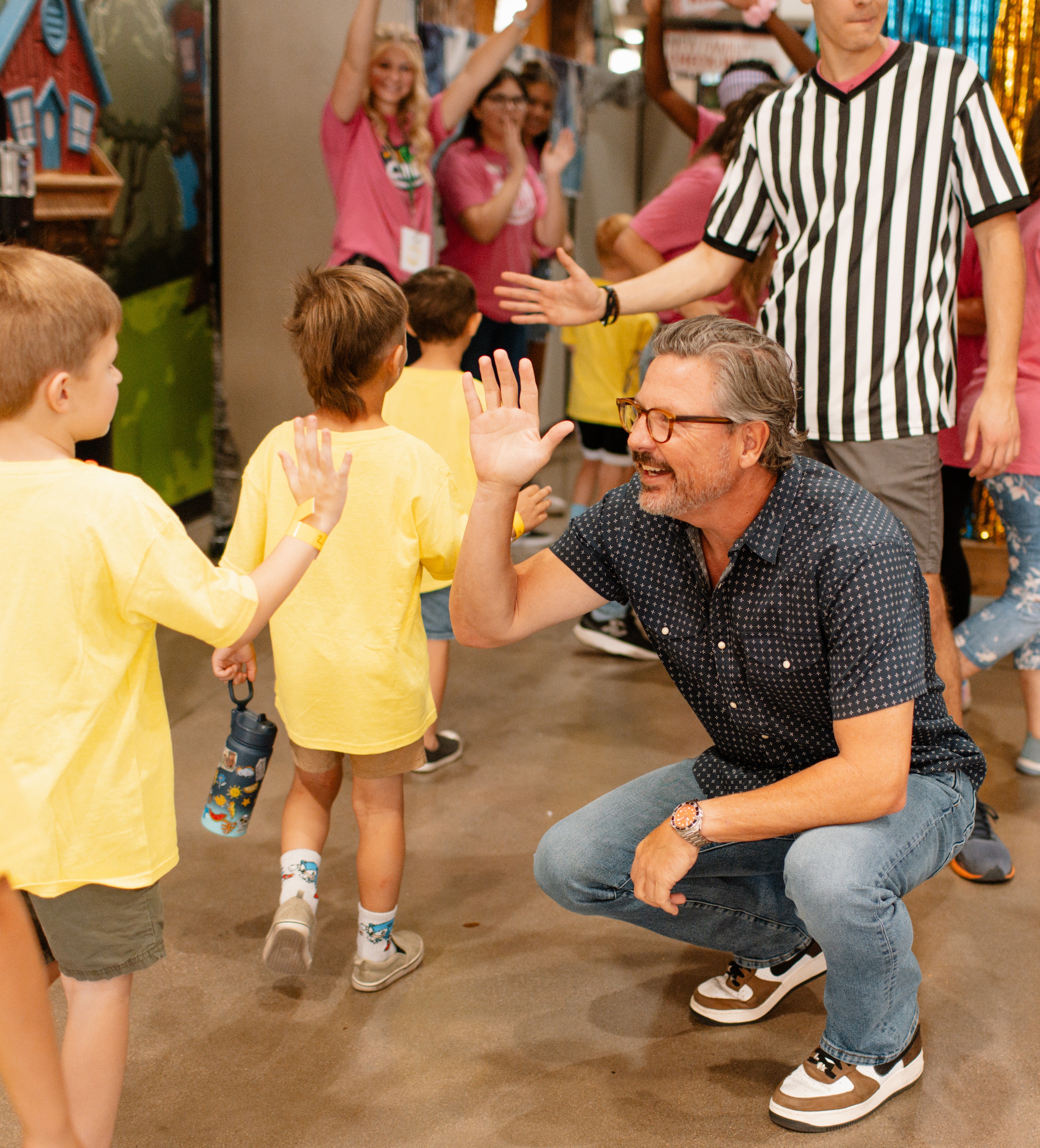 Pastor Chad giving high fives to kids at Sun Valley Community Church